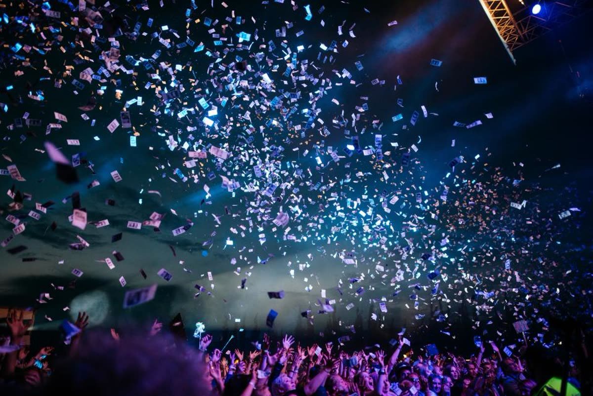 Confetti falling at an event with lights